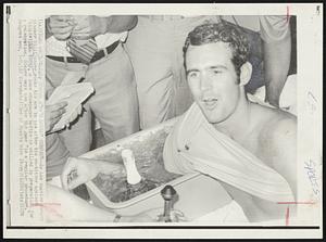 Tub Serves Double Purpose--As Los Angeles Dodger pitcher Bill Singer soaks his arm in ice after his no-hitter against Philadelphia today, a lone champagne bottle is chilled in preparation for a celebration. Singer says ice after the game "is a regular procedure." Dodgers won, 5-0.