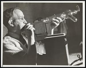 Symphony of Industry The oboe player...this veteran glass blower doesn't get music out of his glass "oboe"; but he must blow just as carefully as his counterpart in a symphony, for the tube he is turning out here will become a part of laboratory apparatus for scientific research.