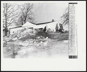 Ice Jam Perils House- Large blocks of river ice from the St. Clair River come grinding ashore in front of a summer cottage here as the largest ice jam of recent years began spreading flood and destruction along the river front. In some cases the ice came through windows into rooms and otherwise damaged the buildings.