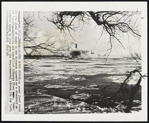 Winter River Mirage- a power plant stack and its cloud of smoke in the distance appears as a steamboat on the far-from-navigable and ice-filled Arkansas River. Temperatures close to zero gave the temperamental stream its icy load.