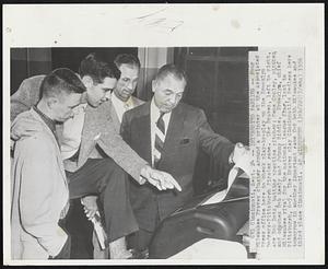 Interested Parties--Fout Milwaukee Braves cluster around a printer at the Associated Press office here to check play-by-play on the Brooklyn Dodgers-Pittsburgh Pirates game. The Braves, left to right, are Bob Botz, batting practice pitcher; Gene Conley, pitcher, and coaches Bob Keely and Johnny Riddle. Brooklyn, chief Milwaukee rival for the national league flag, lost to Pittsburgh, 6-5. The Braves play Cincinnati's Redlegs here tomorrow in another important game for both Milwaukee and third place Cincinnati.