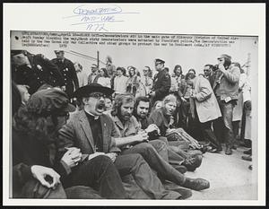 Demonstrators sit in the main gate of Sikorsky Division of United Aircraft Monday blocking the way. About sixty demonstrators were arrested by Stratford police. The demonstration was held by the New Haven Air War Collective and other groups to protest the war in Southeast Asia.