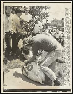 (St. Louis Out) St. Louis: a participant in 6/7 "Hard Hat" parade attacks an anti-war demonstrator on the campus of St. Louis University near the end of the four-mile march. an unidentified woman (background), restrains another marcher who had shoved a second youth to the ground. The marchers attacked when the youths began holding anti-war signs.