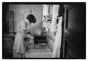 Woman doing laundry at a sink