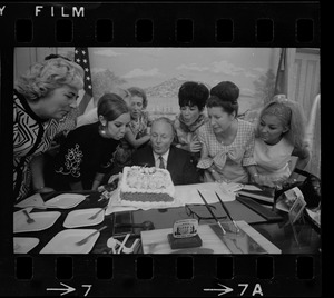 Mayor Collins, who celebrated his 48th birthday yesterday, gets assistance from office aides in blowing out candles on cake