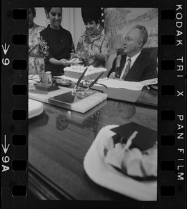 Mayor Collins, who celebrated his 48th birthday yesterday, gets assistance from office aides in blowing out candles on cake