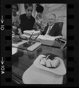 Mayor Collins, who celebrated his 48th birthday yesterday, gets assistance from office aides in blowing out candles on cake