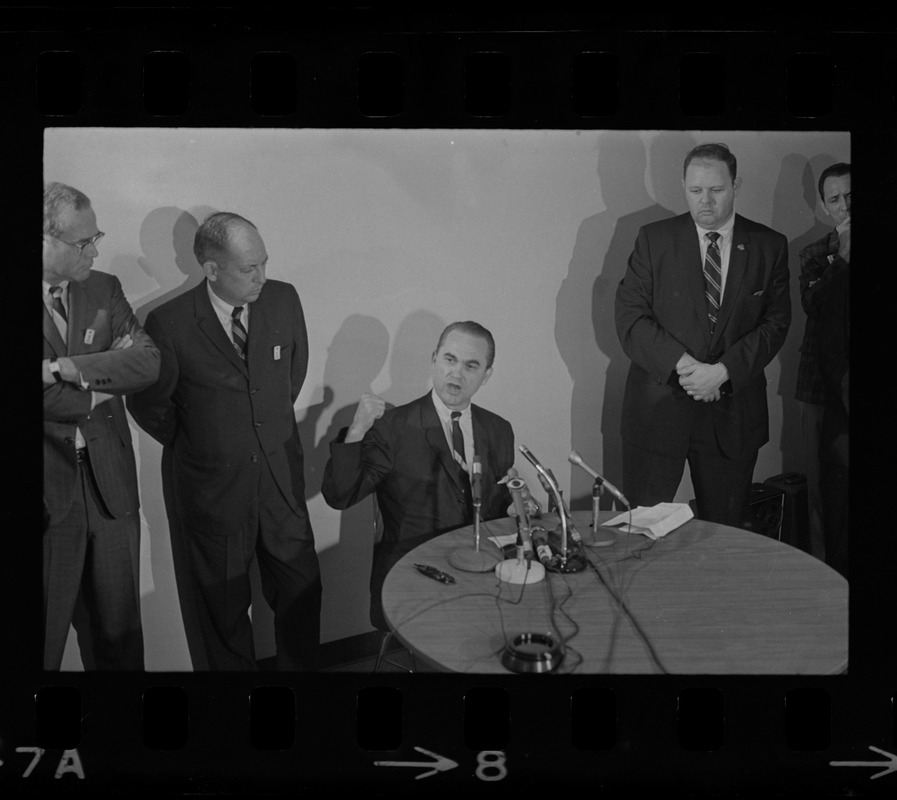 Former Alabama Gov. George Wallace addresses newsmen at Logan Airport during unexpected visit to Hub