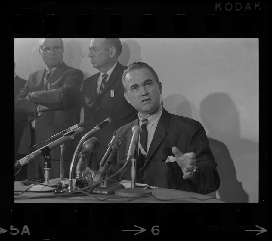 Former Alabama Gov. George Wallace addresses newsmen at Logan Airport during unexpected visit to Hub