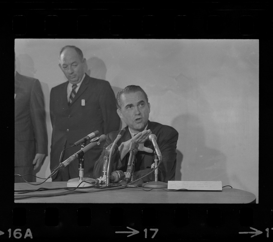 Former Alabama Gov. George Wallace addresses newsmen at Logan Airport during unexpected visit to Hub