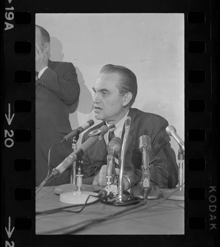 Former Alabama Gov. George Wallace addresses newsmen at Logan Airport during unexpected visit to Hub