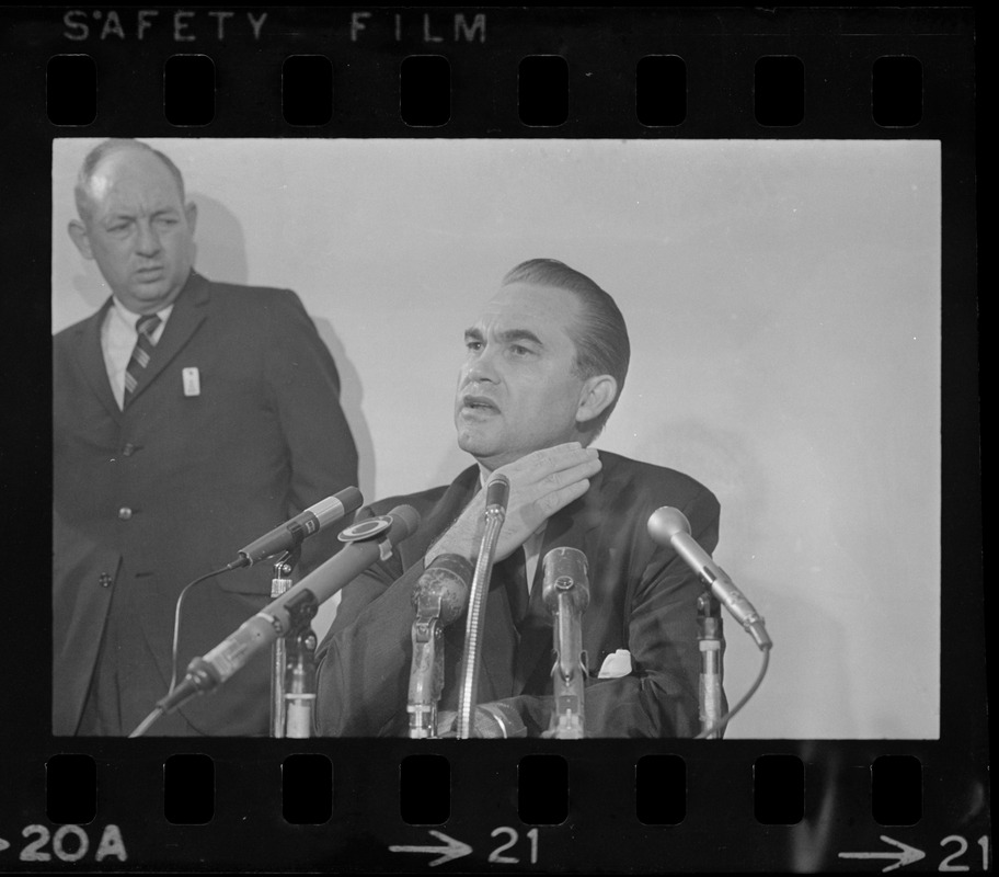 Former Alabama Gov. George Wallace addresses newsmen at Logan Airport during unexpected visit to Hub