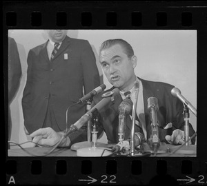 Former Alabama Gov. George Wallace addresses newsmen at Logan Airport during unexpected visit to Hub