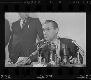 Former Alabama Gov. George Wallace addresses newsmen at Logan Airport during unexpected visit to Hub