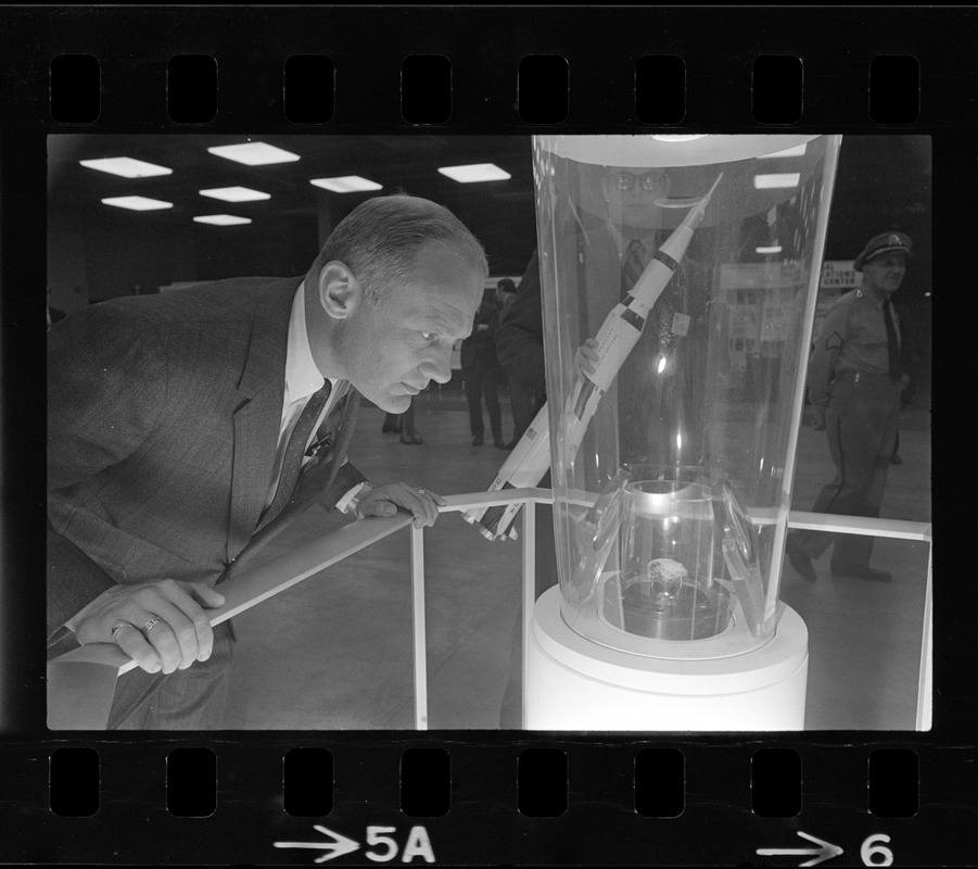 Astronaut Edwin E. Aldrin views a piece of moon rock