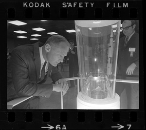 Astronaut Edwin E. Aldrin views a piece of moon rock