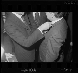 Italian Prime Minister Emilio Colombo pinning medal on man's lapel at dinner in Colombo's honor