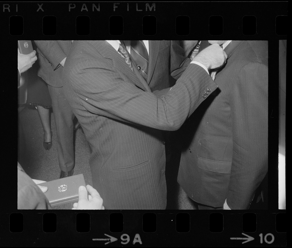 Italian Prime Minister Emilio Colombo pinning medal on man's lapel at dinner in Colombo's honor