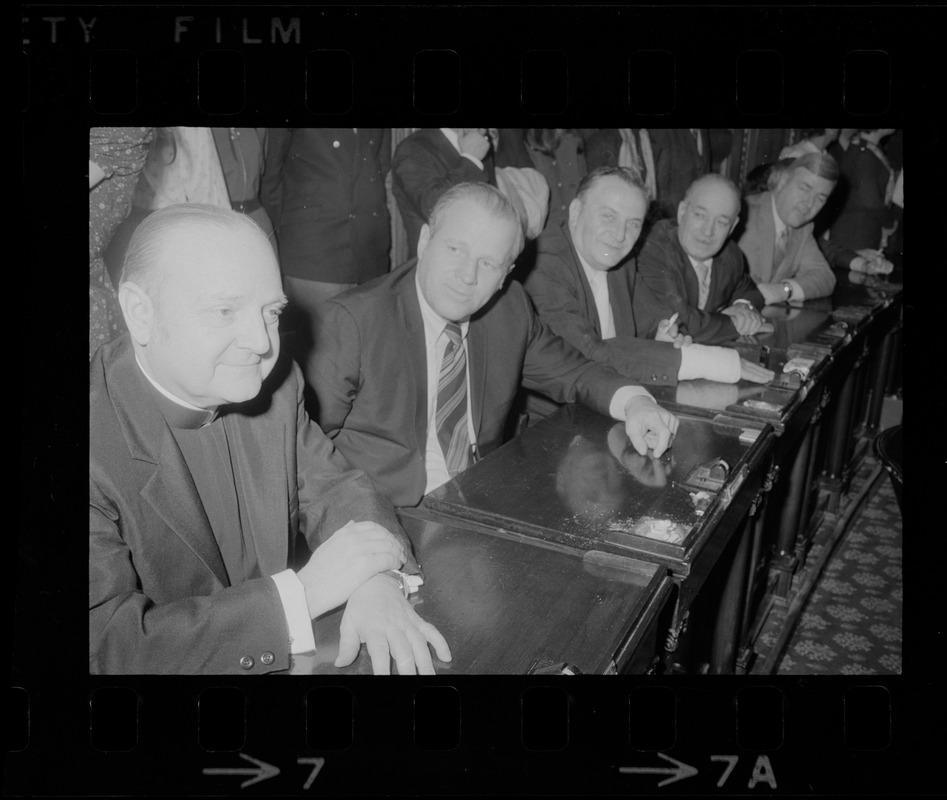 Msgr. Mimie B. Pitaro, left, and other members of the Massachusetts House of Representatives