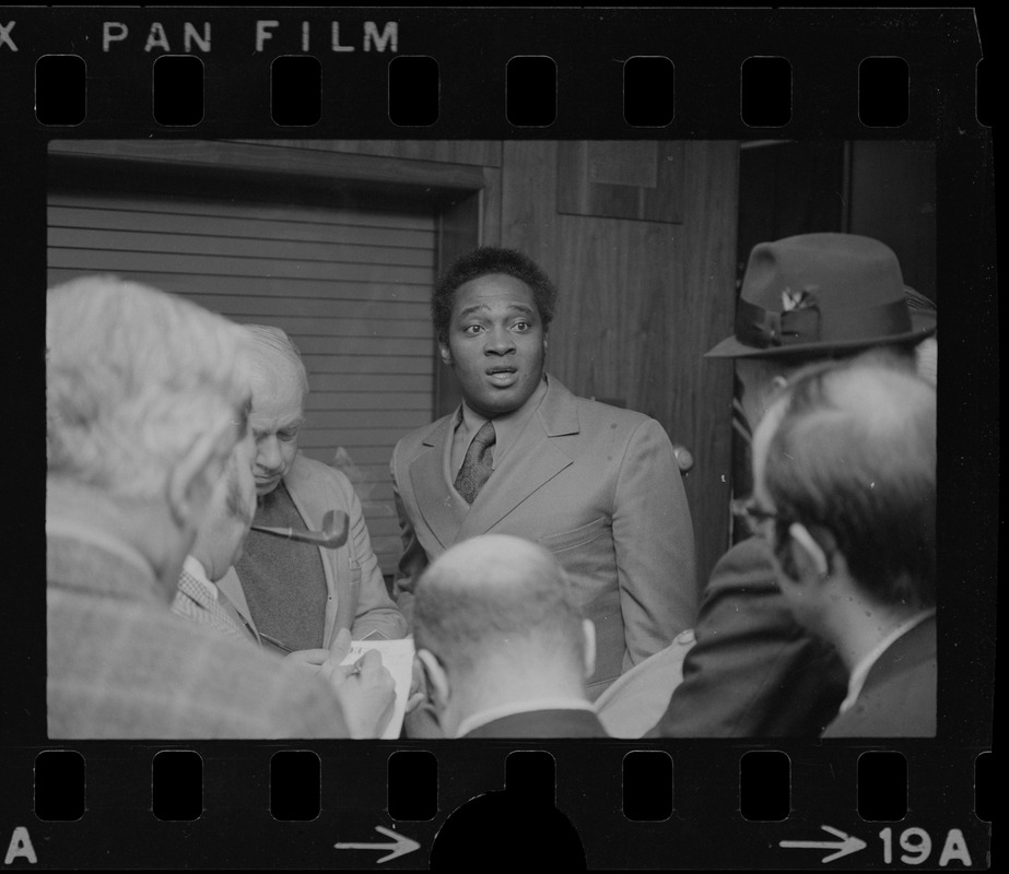 Unidentified men speaking to reporters at the Massachusetts State House ...