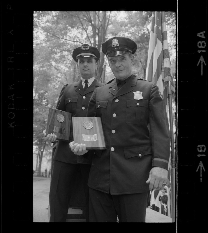 Boston Police Capt. Charles Barry, left, and officer John Corbett during Flag Day exercises at Parkman Bandstand