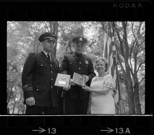 Boston Police Capt. Charles Barry, left, officer John Corbett, and unidentified woman during Flag Day exercises at Parkman Bandstand