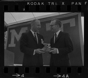 Astronaut Buzz Aldrin, left, presents MIT President Howard Johnson with model of the Gemini 12 spacecraft in which he orbited the earth
