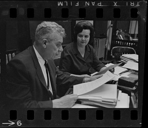 Supt. Of Boston Schools William H. Ohrenberger, left, looks over a subpoena served him along with Mrs. Louise Day Hicks, chairman, right, and all other School Committee members by a Federal Marshall last night