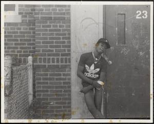 Boy striking a cool pose against wall