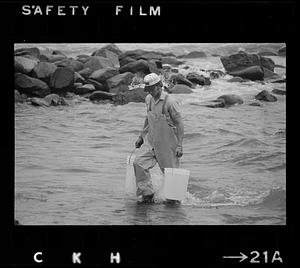 Fisherman gets buckets of seawater, Monhegan Island, Maine