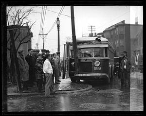 People gathered around a wrecked Melrose bus which has hit a pole