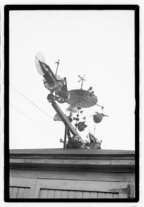 An elaborate device on roof, possibly a weather vane