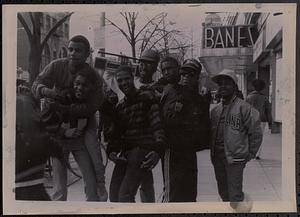 Group of friends posing on the sidewalk
