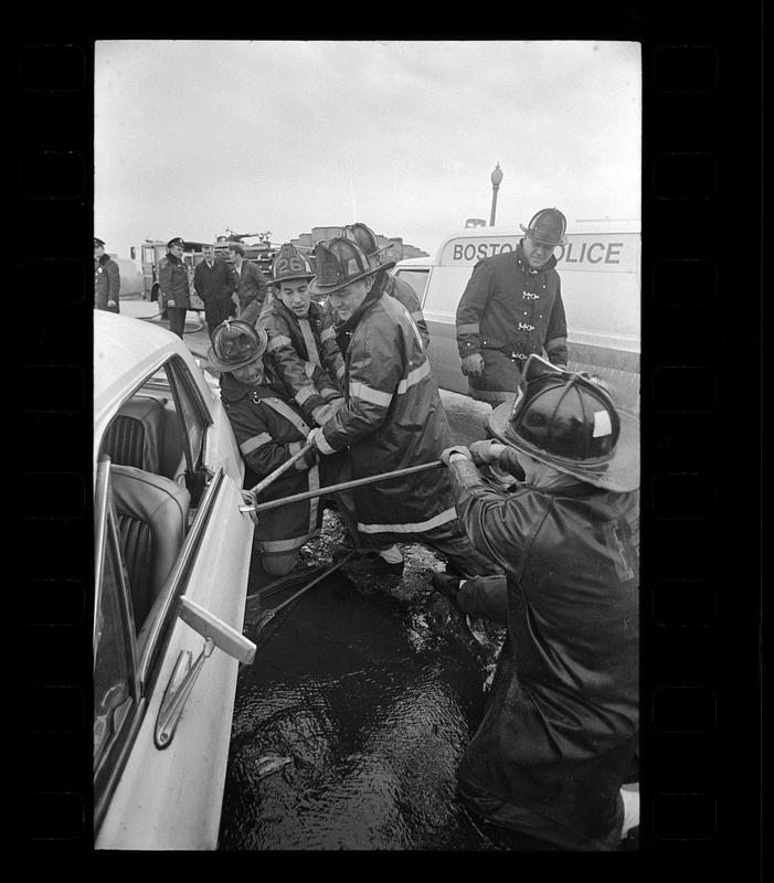 Firemen pry open door of car after accident, Jamaicaway