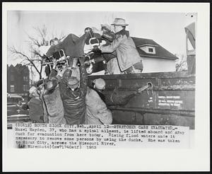 Stretcher Case Evacuated--Hazel Hayden, 37, who has a spinal ailment, is lifted aboard and Army duck for evacuation from here today. Rising flood waters made it necessary to remove some persons by using the ducks. She was waken to Sioux City, across the Missouri River.