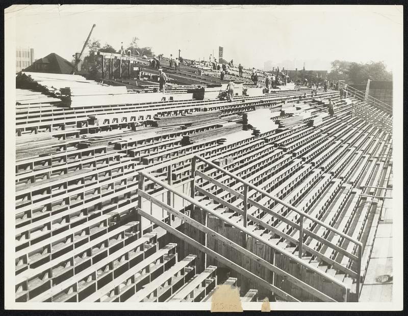 Peaceful scene, this. Rows of naked, wooden planks seats. A crew of workmen, going sensibly about their business. But wait -- just wait. when the World Series opens, there'll not be aenough planking visible here to fashion a toothpick, and chances are the self same workmen will be occupying some of the now vacant space, wielding score cards and, perhaps, an occasional pop bottle, if umpires misbehave. These additional bleachers are to provide for expected extra thousands.