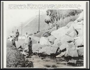 Lima, Peru: Rescue workers stand amidst the tons of rocks which fell on this highway near Lima late 5/31 after a mighty earthquake rocked Peru bringing down homes and buildings and leaving dead and injured over an area spanning half the country. Some towns were reported to be completely destroyed.