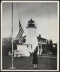 Woman Lighthouse Keeper Serves Coast Guard on Chesapeake Bay. Mrs. Fanny May Salters, keeper of Turkey Point light on Chesapeake Bay and the only woman lighthouse keeper in the U. S. Coast Guard service, raises the Stars and Stripes to the top of the flagpole near the lighthouse. She has been keeper of the light since her husband died in 1925. Mrs. Salters does not long for the good old days, because she prefers the modern conveniences. A flip of the electric switch now sends Turkey Point's beams out over the Bay, but in the old days there was back-breaking toil to keep the oil lamps burning.