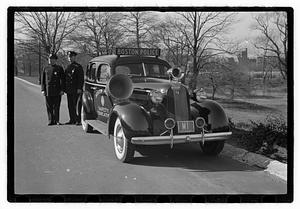 Policemen standing next to Boston Police Safety Education vehicle, Back Bay Fens