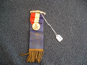 Blue ribbon with gold lettering and fringe