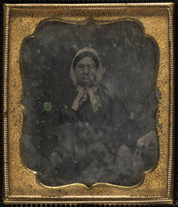Portrait of woman in bonnet holding book