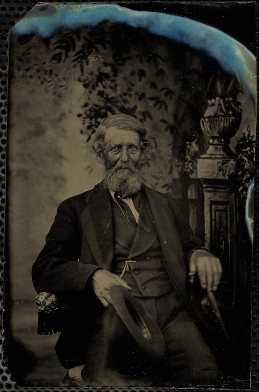 Portrait of man holding his hat