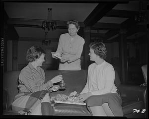 Three women looking at card