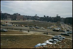 Cars parked around vacant lot, future site of City Hall Plaza