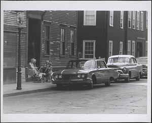 Women and children in doorway with stroller on unidentified street, Boston