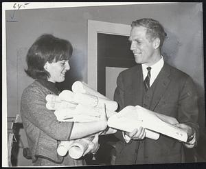 Secretary of State Kevin White looks to a pil of bills his clerk, Judy Dooley of Boston, is carrying.