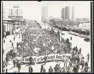 Thousands of demonstrators march down Geary St. en route to Golden Gate Park polo field for rally against the Vietnam war. In background is Cathedral Hill.