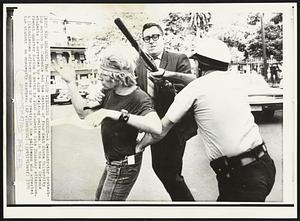 Club Wielding Arrest -- A demonstrator protesting action in Cambodia and the deaths of four Kent State University students is arrested by a club wielding policemen in the New Orleans French Quarter during a march by 1000 students late Thursday afternoon. A plainclothes officer moves in to restrain the policeman who arrested the student on obscenity charges.
