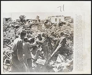 Victim Taken From Quake Rubble -- A soldier hands the body of a young Iranian earthquake victim to relatives after digging the child out of building wreckages in the shattered oasis village of Dan-Isfahan yesterday. The village, 150 miles northwest of Tehran, was one of hardest hit communities in Iran's weekend disaster.