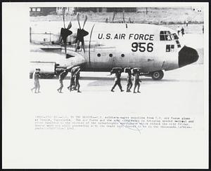 U.S. To The Rescue -- U.S. soldiers carry supplies from U.S. Air Force plane at Skopje, Yugoslavia. The Air Force and the Army cooperated in bringing needed medical and other supplies to the victims of the catastrophic earthquake which struck the city Friday. Rescue work was still proceeding with the death toll feared to be in the thousands.